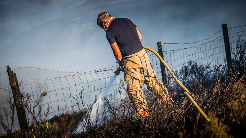 firefighter douses flash fire during Saddleworth Moor fires