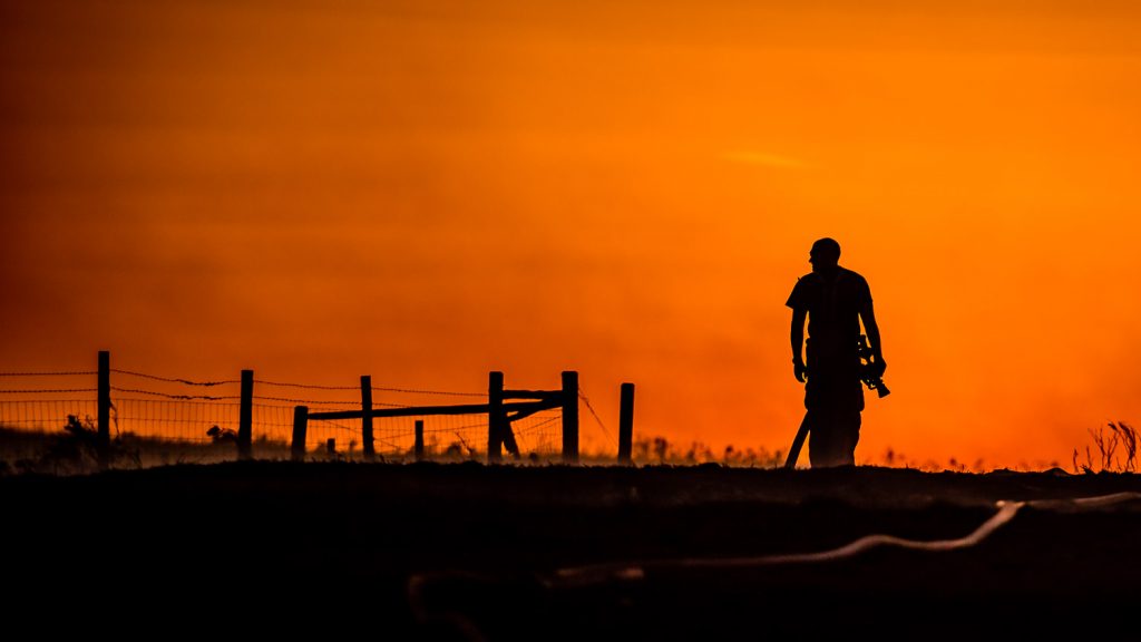 Firefighter silhouetted against the sunset