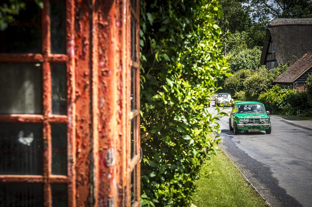 old phone box with classic cars