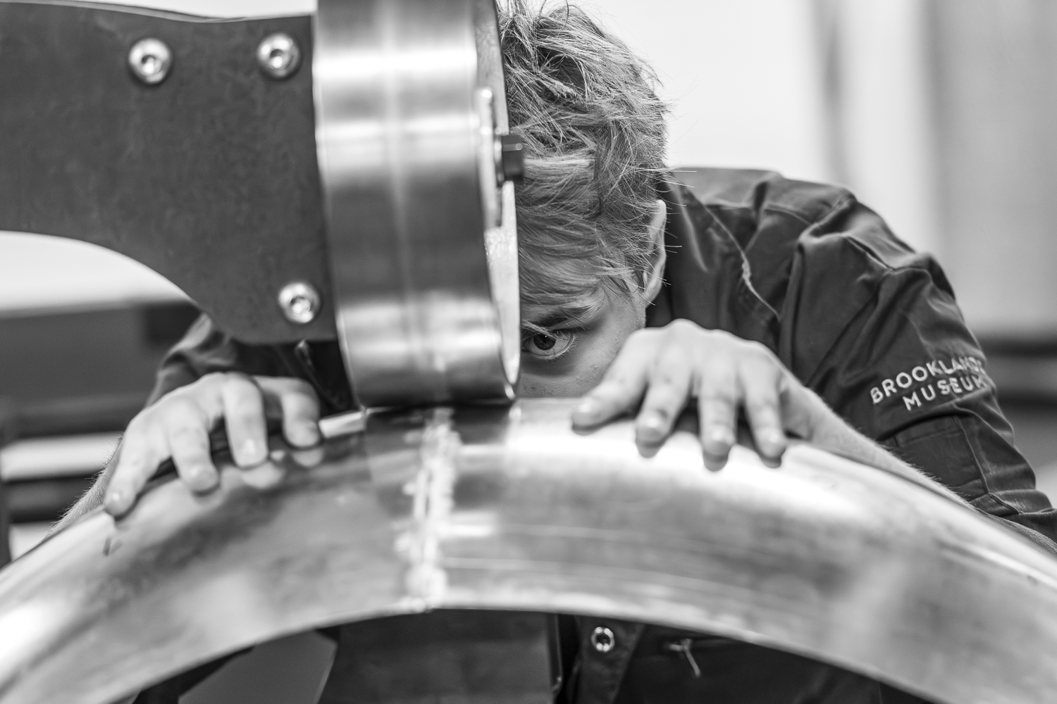 apprentice using English wheel